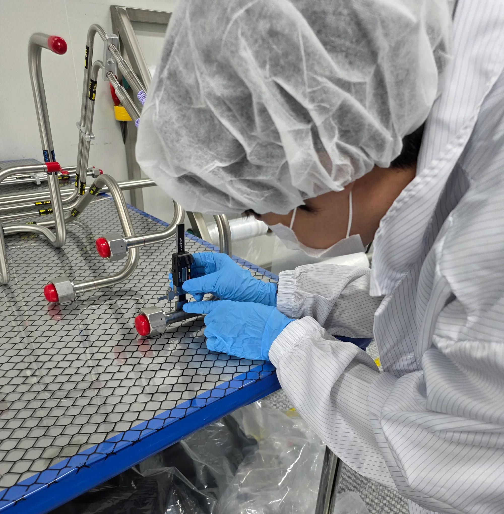 Supplier quality inspector checking weld bead height with a step gauge