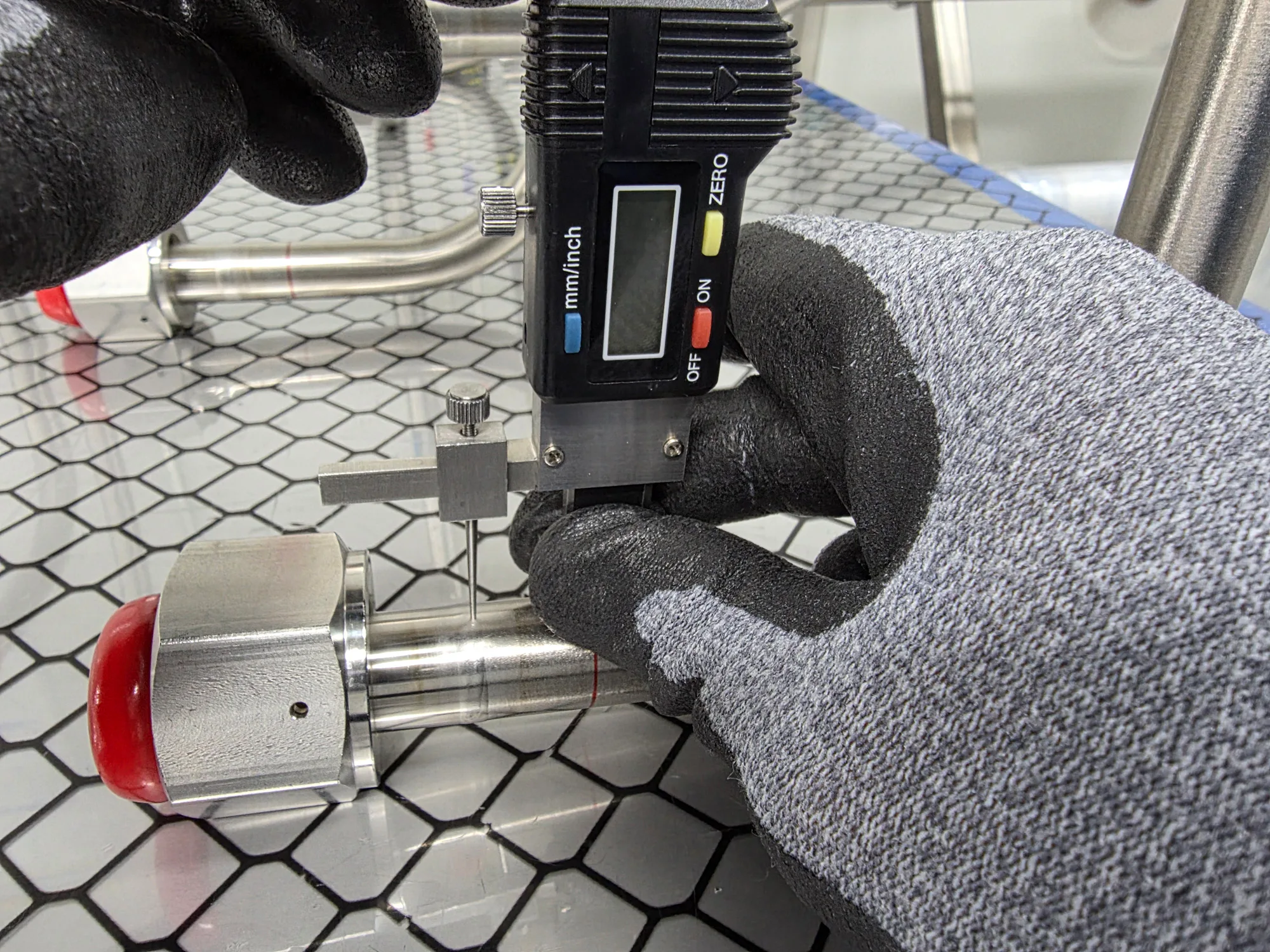 A step gauge measuring weld bead height on piping