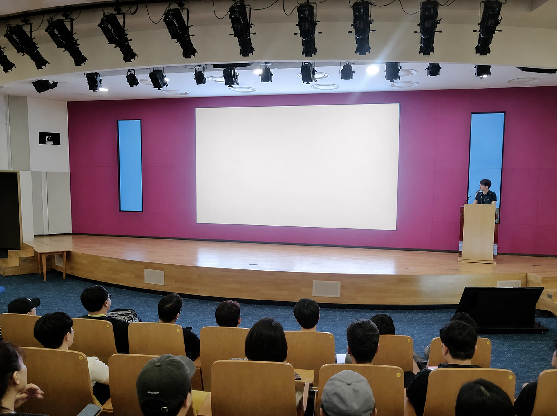 Workers attending monthly safety and health training in an auditorium